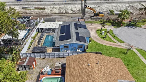 an aerial view of residential houses with outdoor space and river view