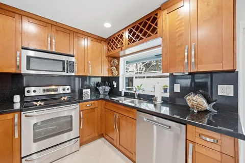 a kitchen with stainless steel appliances a stove sink and cabinets