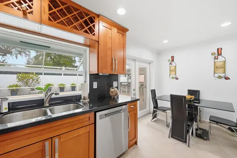 a kitchen with stainless steel appliances granite countertop a sink and a cabinets