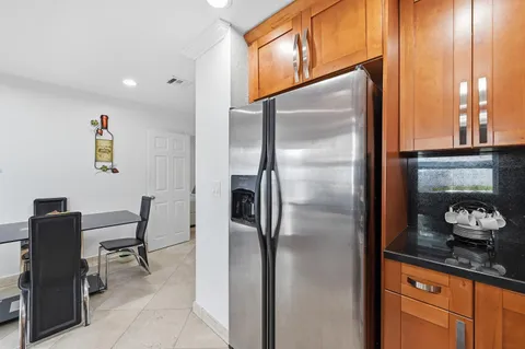 a kitchen with granite countertop stainless steel appliances a refrigerator and counter space