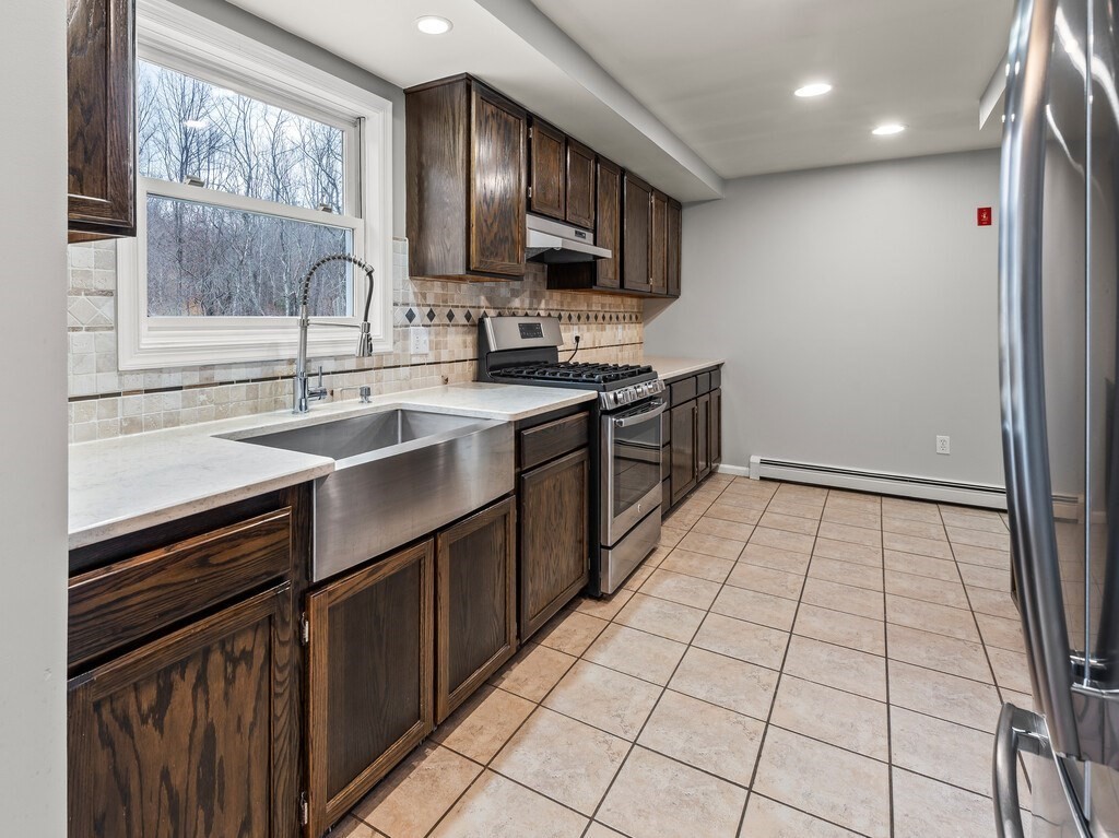 281 Brooks Station Road, Unit 1 Princeton, MA 01541 - Photo 12 of 36 a kitchen with a sink stove top oven and cabinets