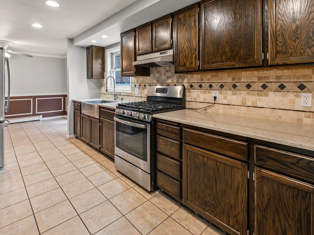 281 Brooks Station Road, Unit 1 Princeton, MA 01541 - Photo 13 of 36 a kitchen with stainless steel appliances granite countertop a stove a sink and a microwave