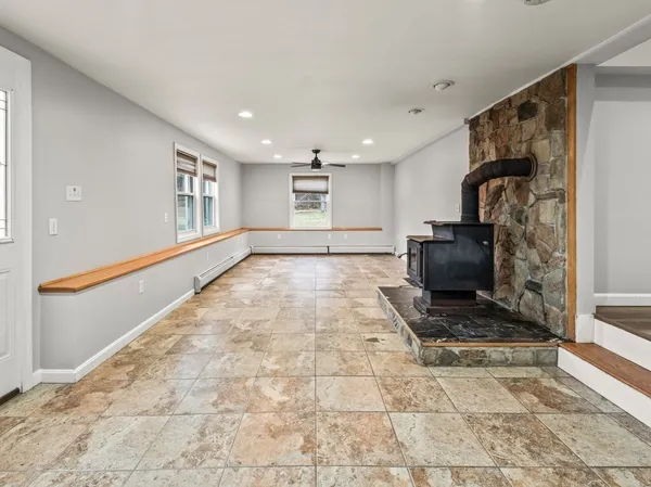 a view of an empty room and fire place