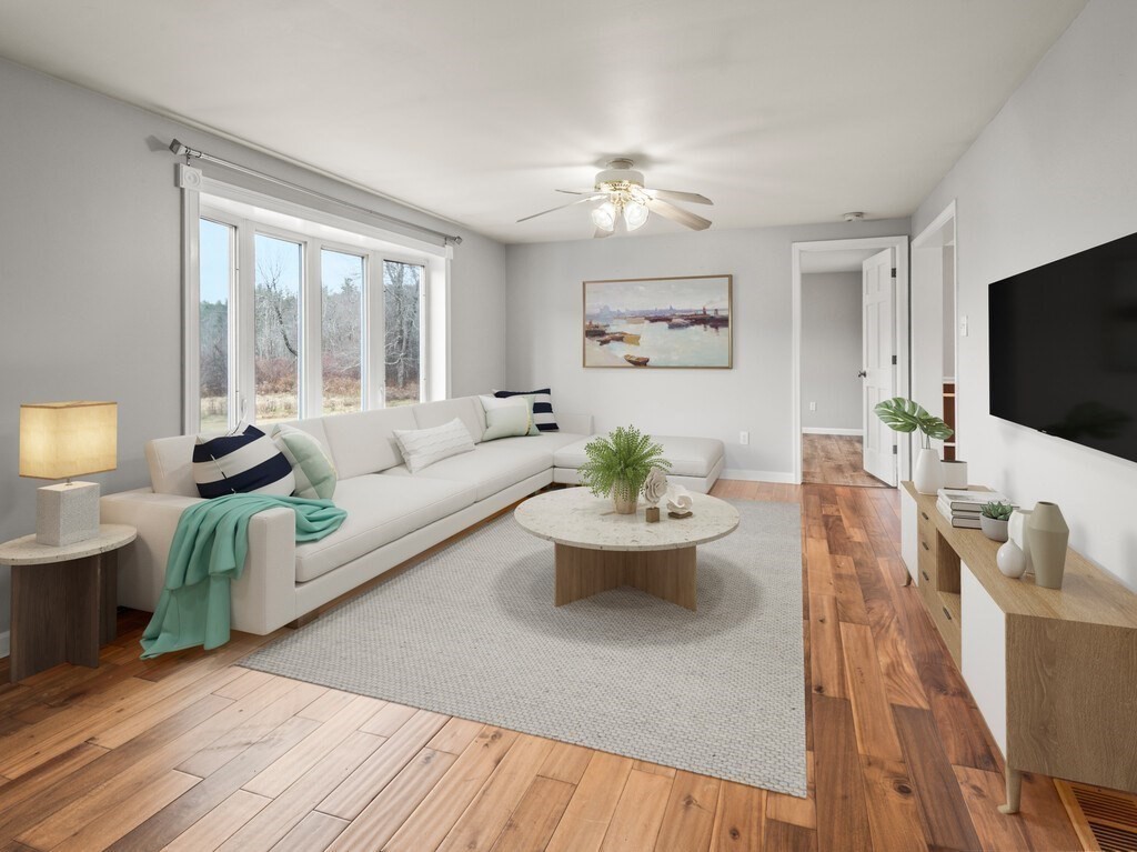 281 Brooks Station Road, Unit 1 Princeton, MA 01541 - Photo 4 of 36 a living room with furniture a flat screen tv and a large window