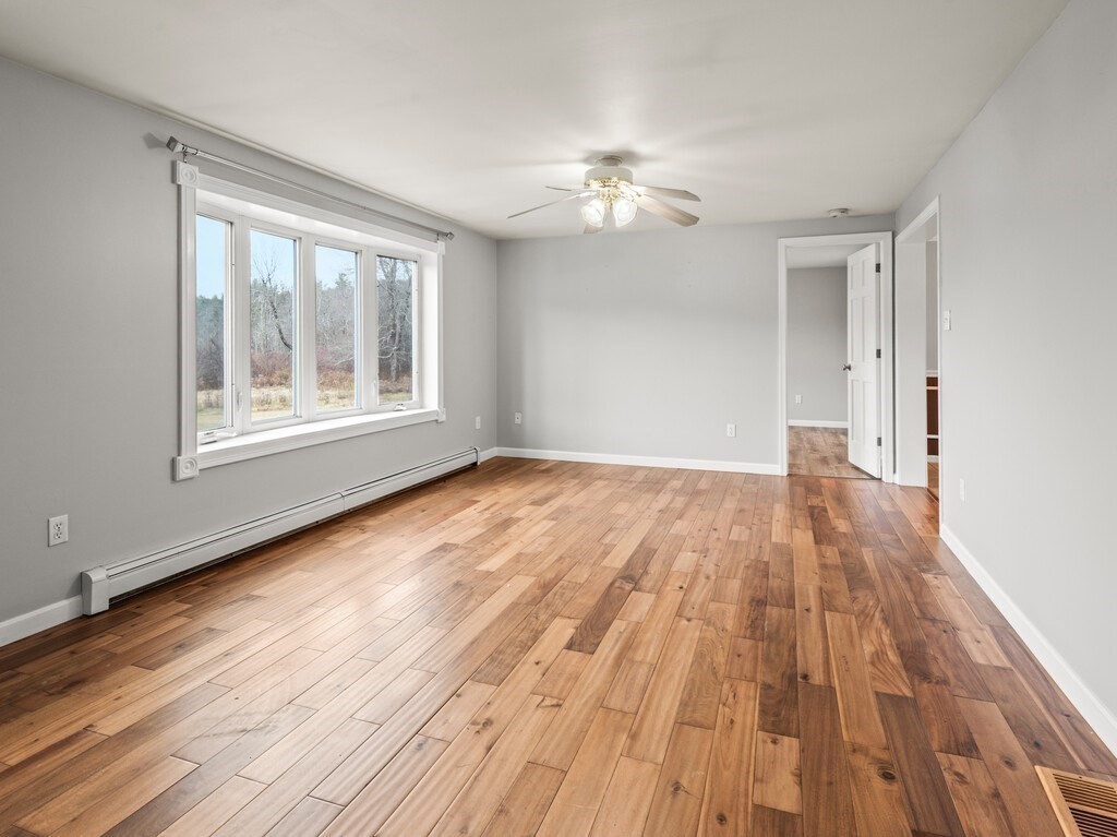 281 Brooks Station Road, Unit 1 Princeton, MA 01541 - Photo 5 of 36 a view of empty room with wooden floor and fan