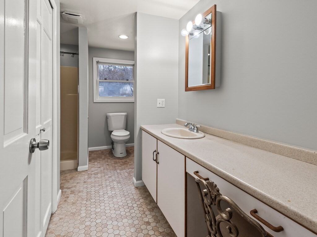 281 Brooks Station Road, Unit 1 Princeton, MA 01541 - Photo 8 of 36 a spacious bathroom with a double vanity sink a toilet and a mirror