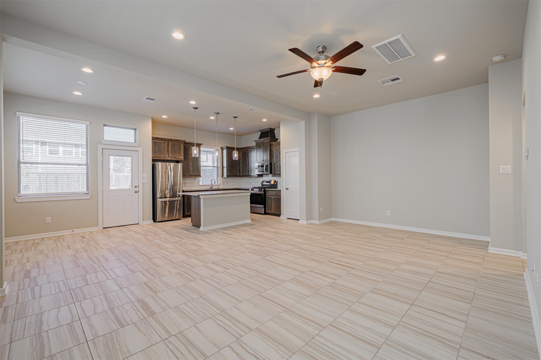 19622 Talley Valley Drive Cypress, TX 77433 - Photo 5 of 18 a view of a kitchen with a sink and dishwasher a refrigerator with wooden floor