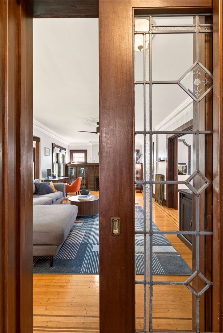 29 Elmcroft Road Rochester, NY 14609 - Photo 5 of 42 Leaded glass pocket doors are set between the livi
