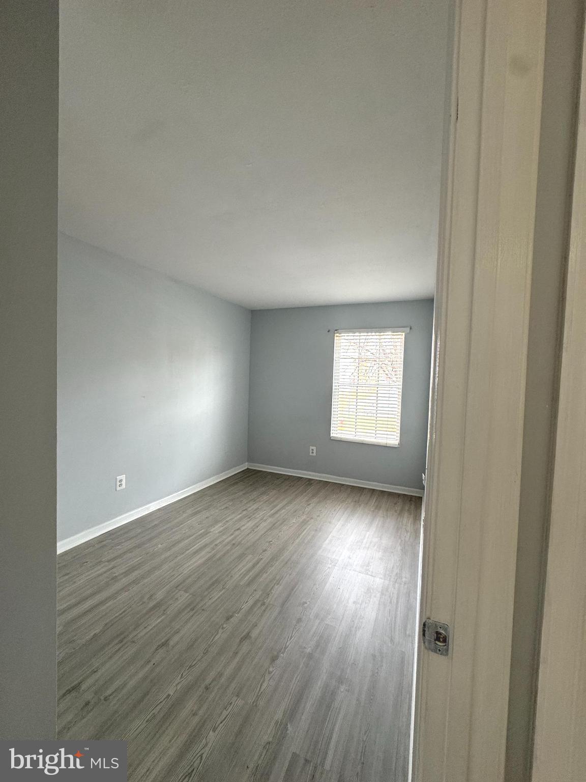 114 Prosperity Avenue Southeast, Unit C Leesburg, VA 20175 - Photo 11 of 18 an empty room with wooden floor and windows