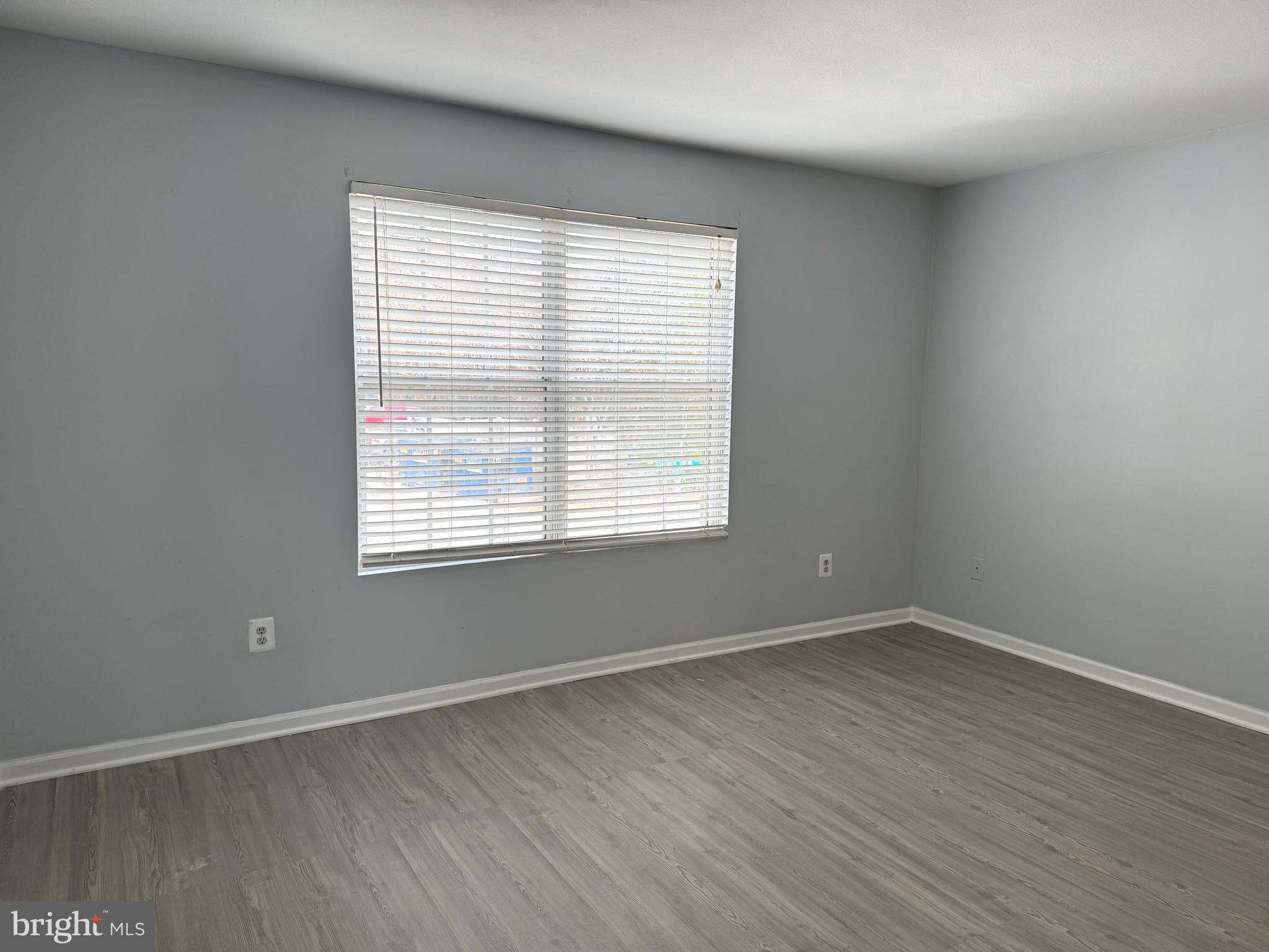 114 Prosperity Avenue Southeast, Unit C Leesburg, VA 20175 - Photo 14 of 18 wooden floor in an empty room with a window