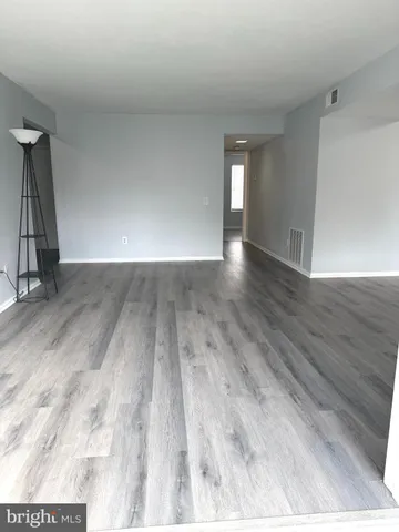 a view of an empty room and wooden floor