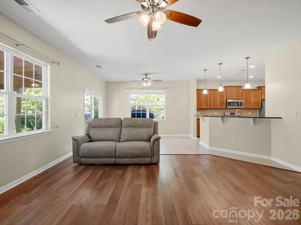 a kitchen with granite countertop a refrigerator stove and microwave