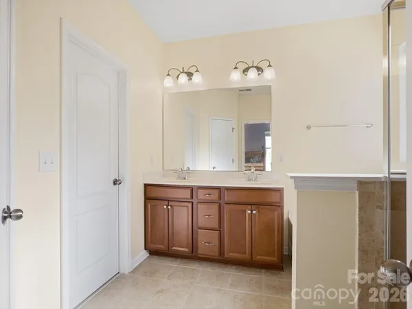 a bathroom with a sink double vanity and a shower