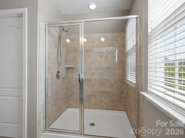a bathroom with a granite countertop sink a toilet and shower