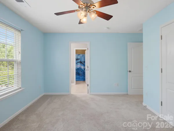a bathroom with a sink a toilet and shower curtain