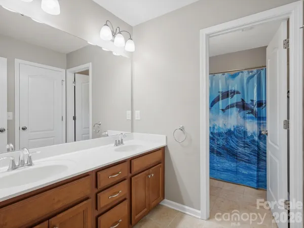 a view of a patio with table and chairs potted plants with floor to ceiling window
