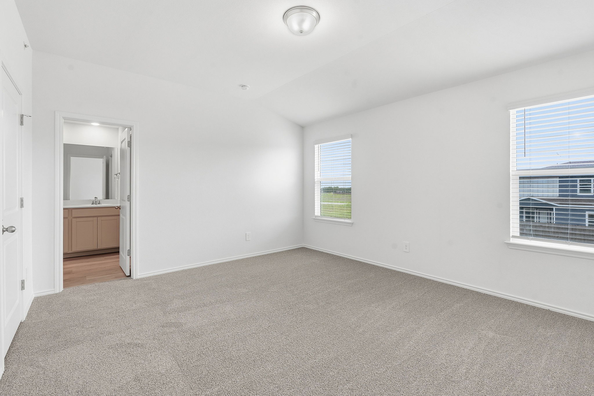164 Cinnabar Lane, Unit 5 Kyle, TX 78640 - Photo 12 of 21 Spacious room featuring neutral carpeting and white walls