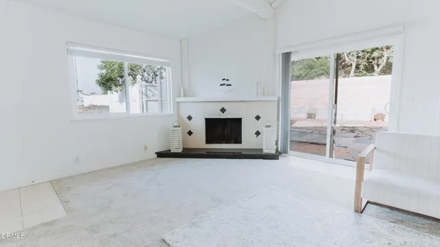 a kitchen with stainless steel appliances granite countertop a stove top oven a fireplace a dining table and chairs