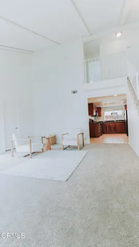 a living room with furniture and a lamp