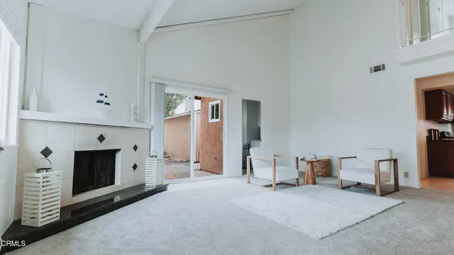 a view of a livingroom with furniture and a fireplace