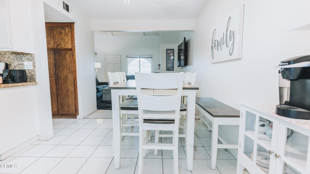 1020 Dunes Street Oxnard, CA 93035 - Photo 49 of 75 a kitchen with stainless steel appliances kitchen island granite countertop a refrigerator and cabinets