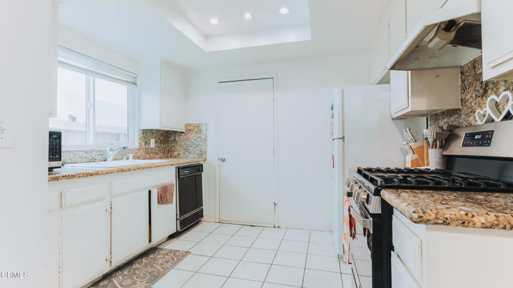 1020 Dunes Street Oxnard, CA 93035 - Photo 51 of 75 a kitchen that has a sink and a stove