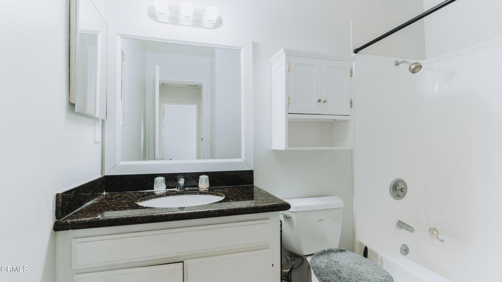 1020 Dunes Street Oxnard, CA 93035 - Photo 61 of 75 a bathroom with a granite countertop sink toilet and shower