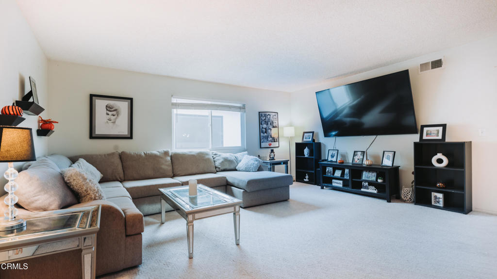 1020 Dunes Street Oxnard, CA 93035 - Photo 63 of 75 a living room with furniture and a flat screen tv