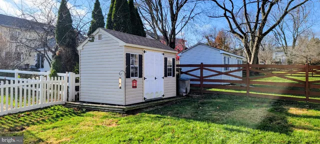a view of a yard with wooden fence