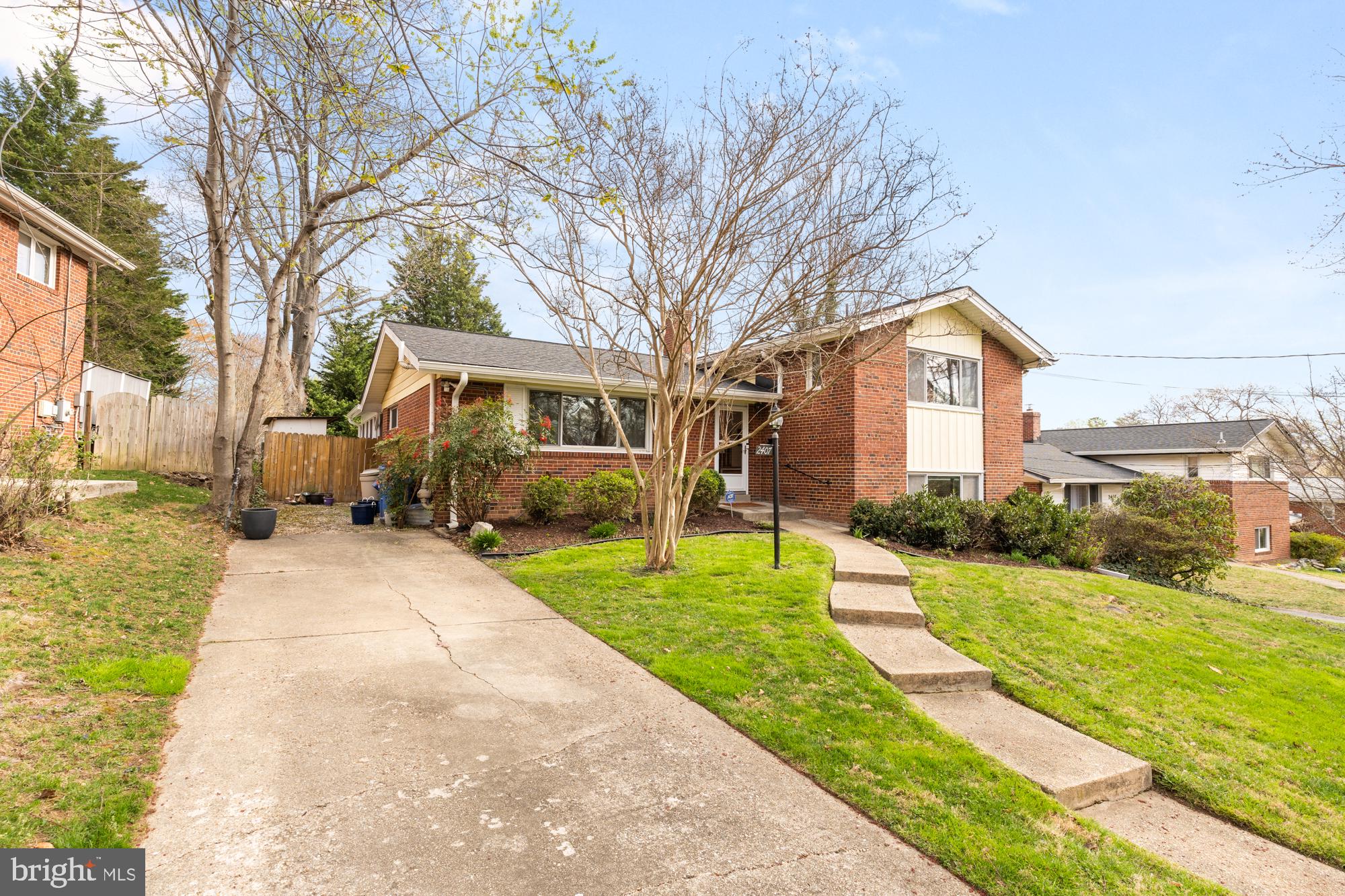 2407 Harmon Road Silver Spring, MD 20902 - Photo 1 of 39 a front view of a house with a yard and trees