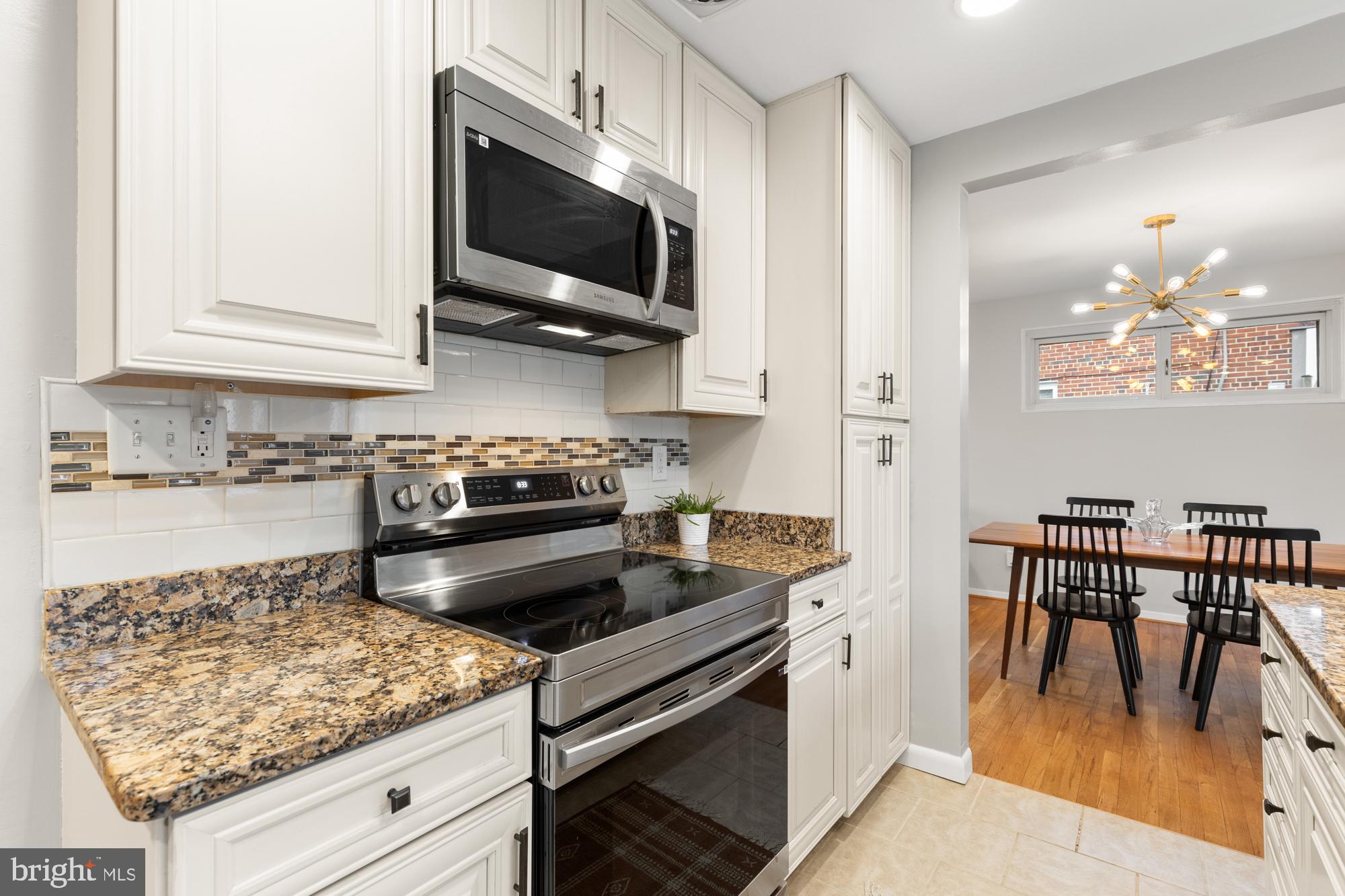 2407 Harmon Road Silver Spring, MD 20902 - Photo 12 of 39 a kitchen with a stove and a white cabinets