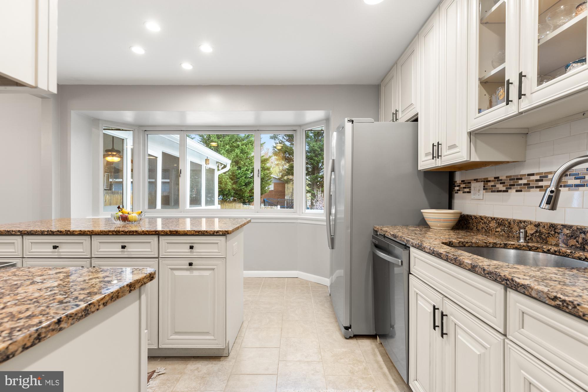 2407 Harmon Road Silver Spring, MD 20902 - Photo 14 of 39 a kitchen with a sink stove and cabinets
