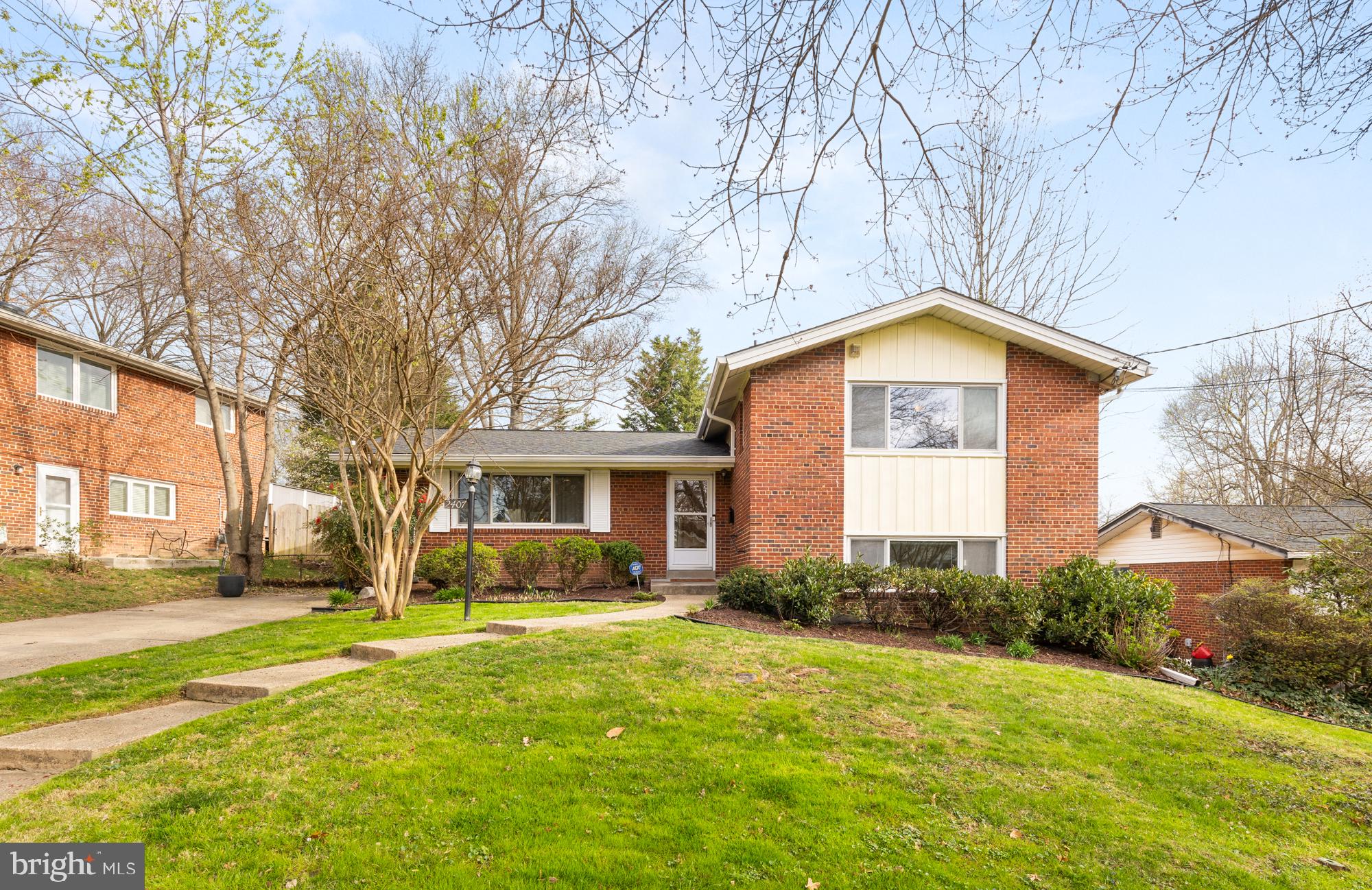 2407 Harmon Road Silver Spring, MD 20902 - Photo 2 of 39 a front view of house with yard and trees around