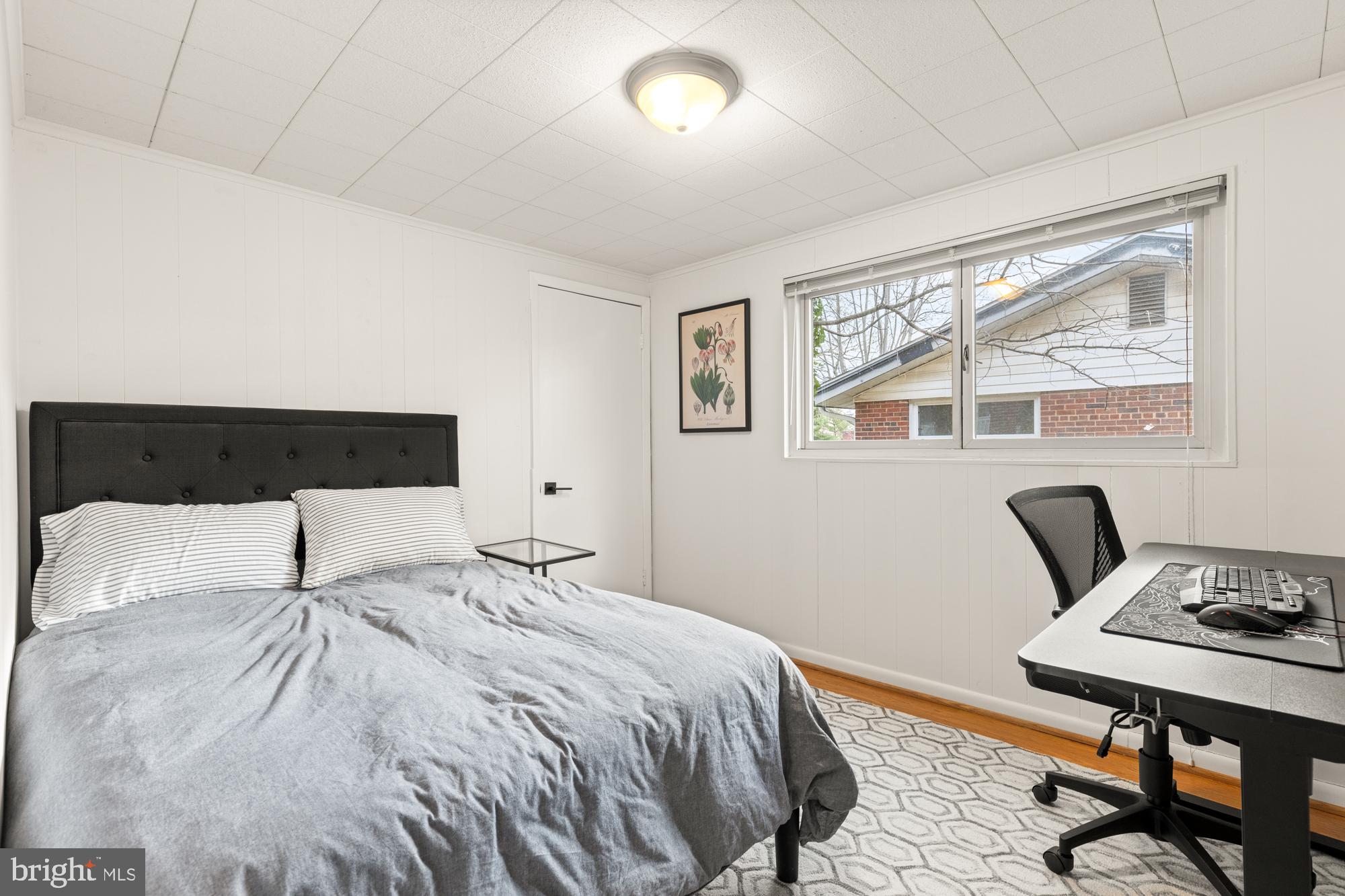 2407 Harmon Road Silver Spring, MD 20902 - Photo 34 of 39 a bedroom with a bed and a table in it