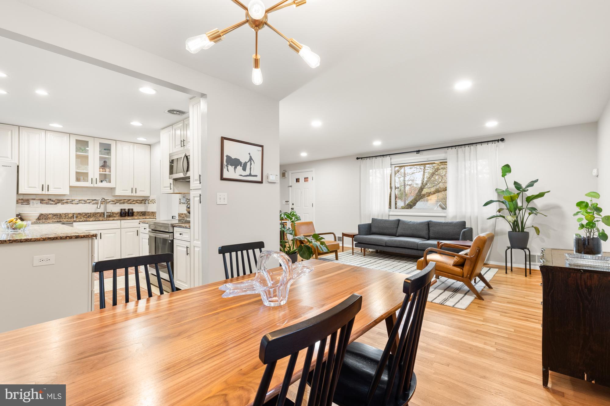 2407 Harmon Road Silver Spring, MD 20902 - Photo 8 of 39 a view of a dining room and livingroom with furniture wooden floor a chandelier