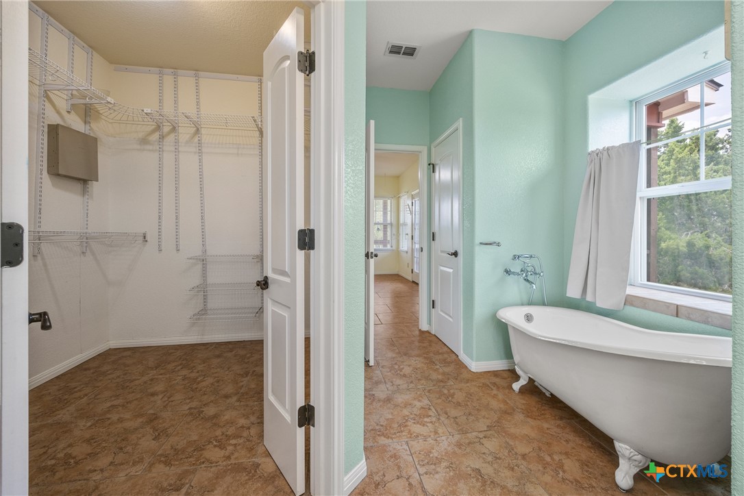 845 Rutherford Fischer, TX 78623 - Photo 15 of 39 a bathroom with a tub shower and sink