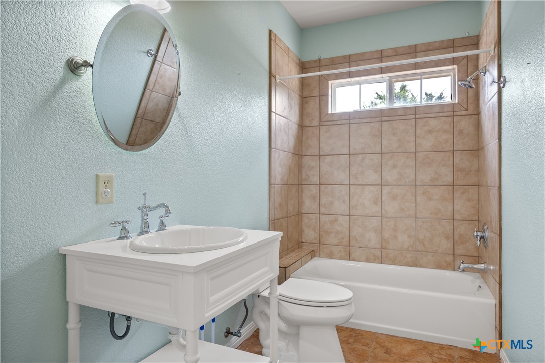 845 Rutherford Fischer, TX 78623 - Photo 19 of 39 a bathroom with a sink a toilet and bathtub