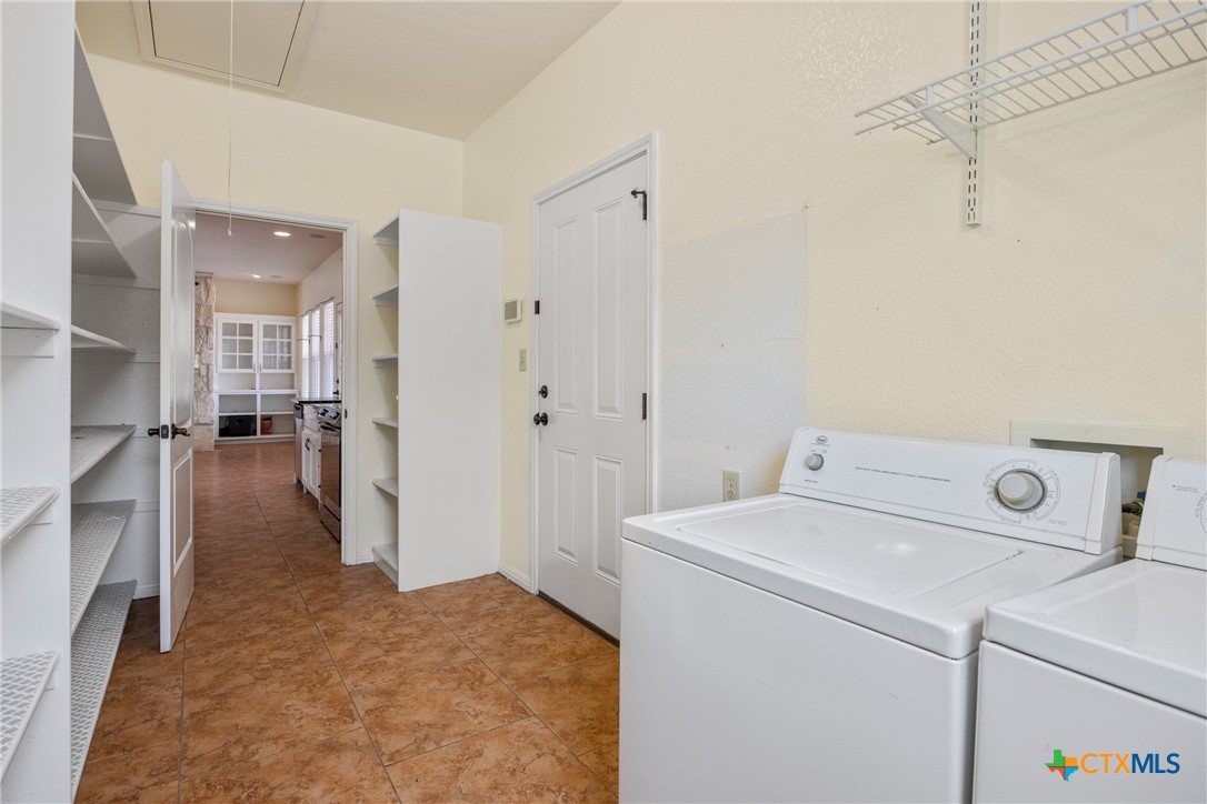 845 Rutherford Fischer, TX 78623 - Photo 22 of 39 a view of storage and utility room with washer and dryer