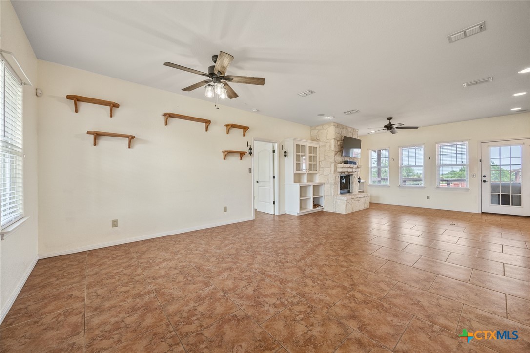 845 Rutherford Fischer, TX 78623 - Photo 4 of 39 a view of empty room with wooden floor and windows