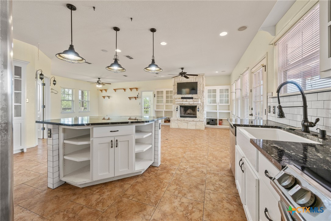 845 Rutherford Fischer, TX 78623 - Photo 8 of 39 a large kitchen with stainless steel appliances granite countertop a stove a sink a oven and a island with wooden floor