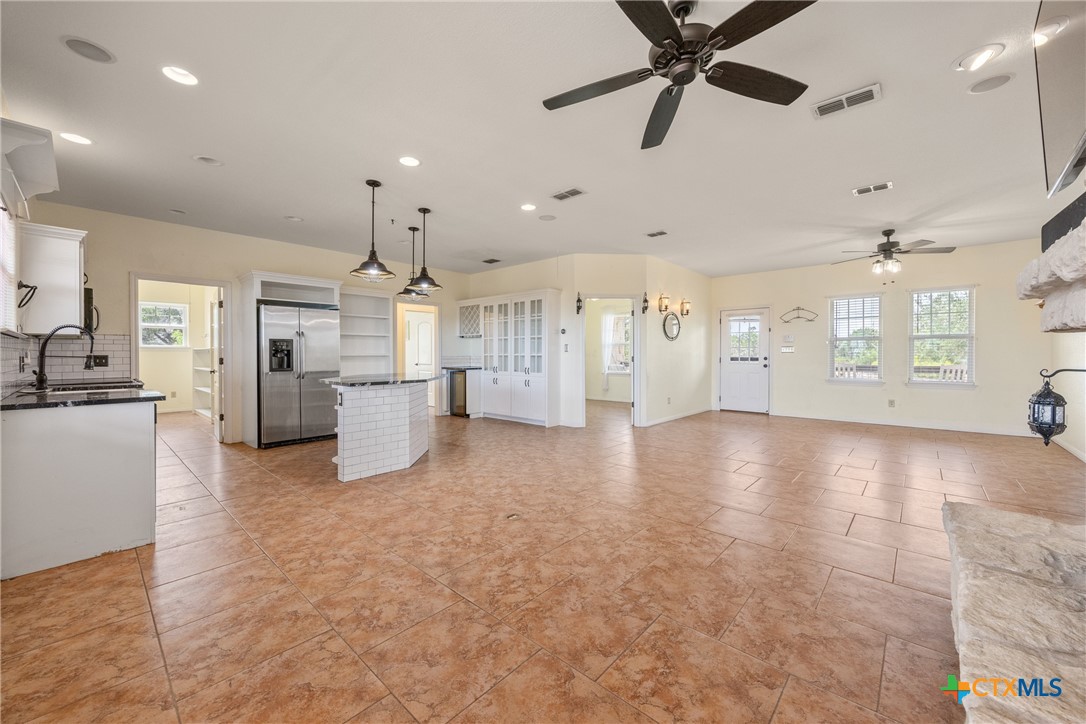 845 Rutherford Fischer, TX 78623 - Photo 9 of 39 a view of a kitchen with a sink and a refrigerator