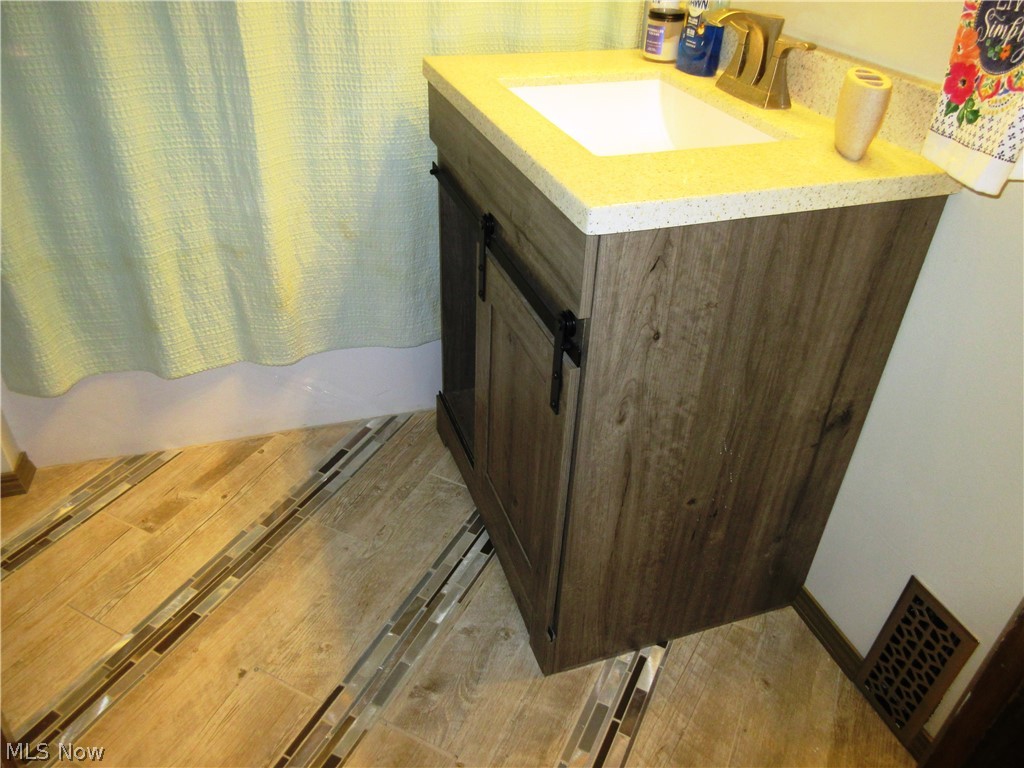 415 Randolph Road Mogadore, OH 44260 - Photo 13 of 30 Remodeled first floor bath with beautiful flooring, sink and cabinet.