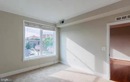 a view of an empty room with a window