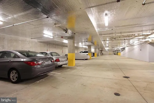a view of parking garage with cars parked