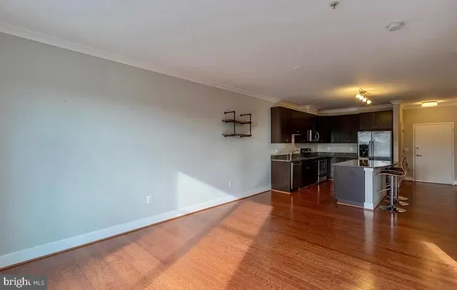 a kitchen with stainless steel appliances a refrigerator and a stove top oven