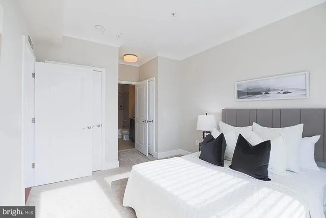 a bedroom with a bed and a painting