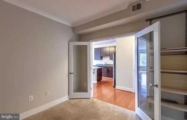 a view of a hallway with dining room and wooden floor