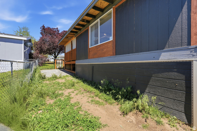 2500 North Fort Lane, Unit 220 Layton, UT 84041 - Photo 20 of 23 Exterior featuring dark vertical siding, wood-finish accents, and an exposed rafter tail roofline