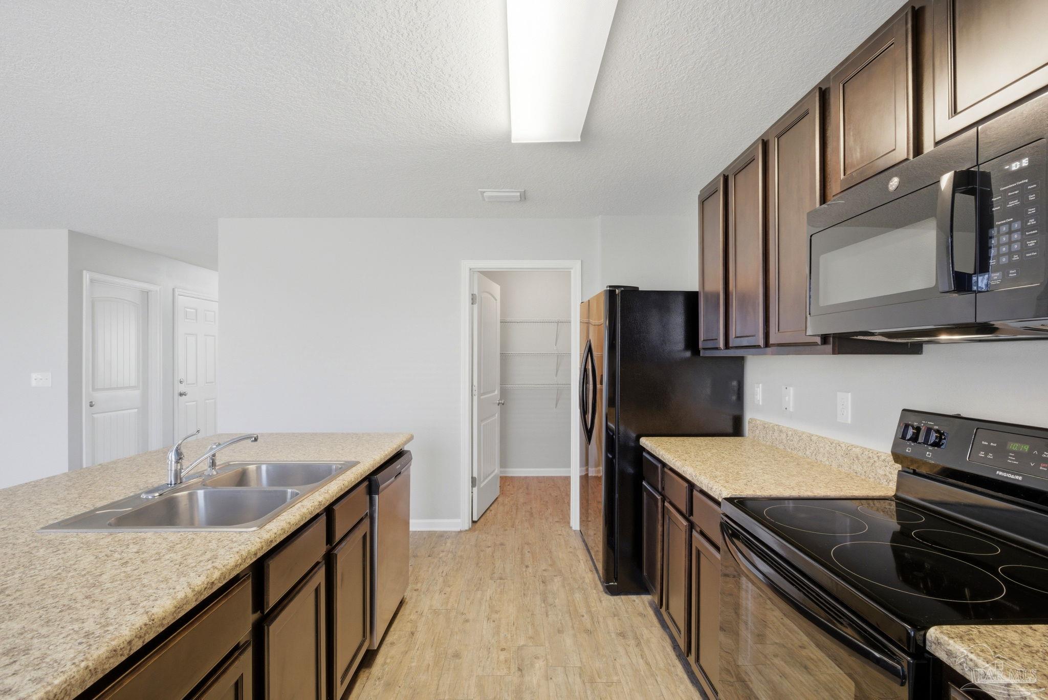 5881 Bay Tree Court Milton, FL 32570 - Photo 13 of 51 a kitchen with stainless steel appliances granite countertop a sink stove and refrigerator