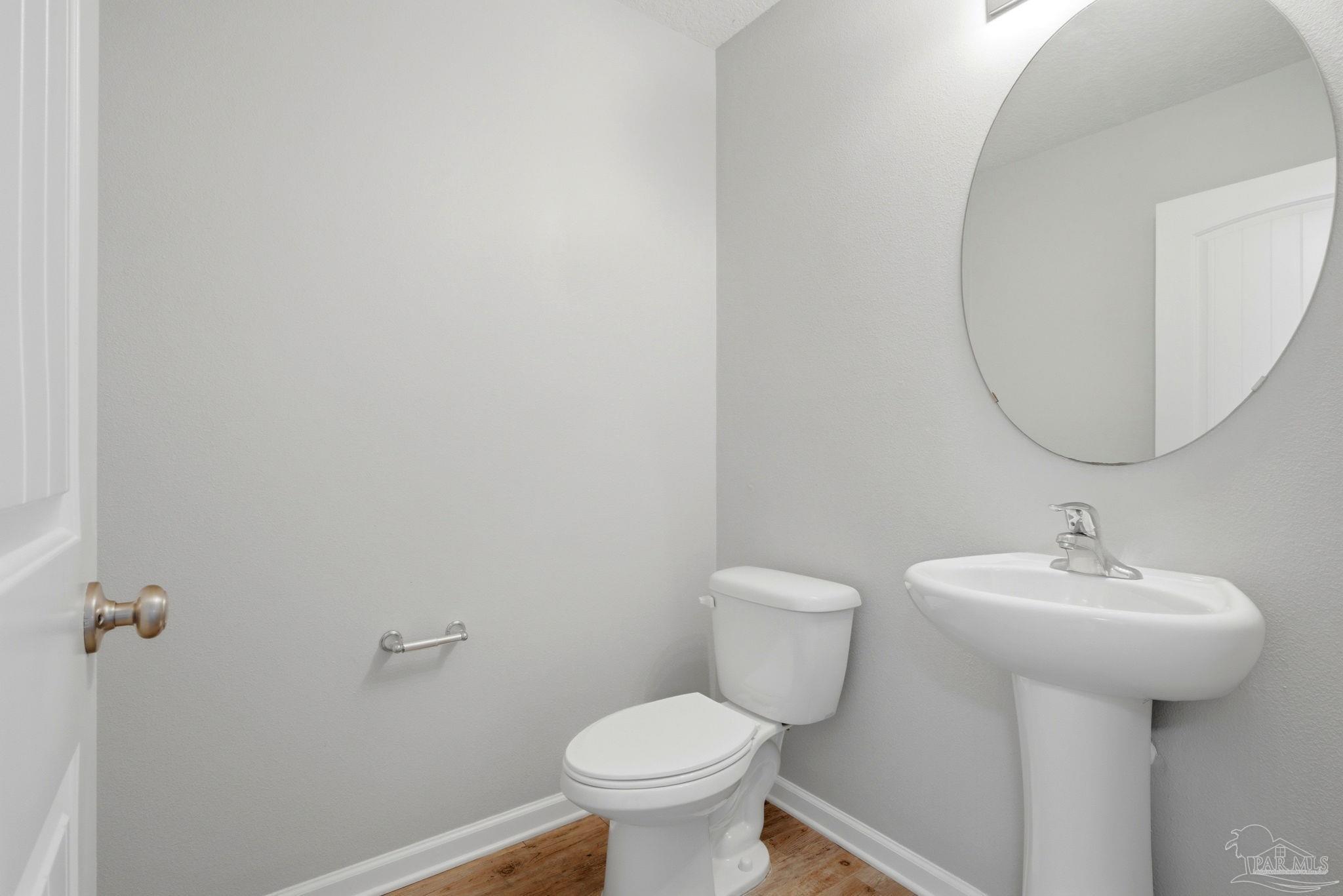 5881 Bay Tree Court Milton, FL 32570 - Photo 14 of 51 a bathroom with a sink toilet and a mirror